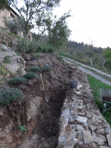 clearing away soil below wall